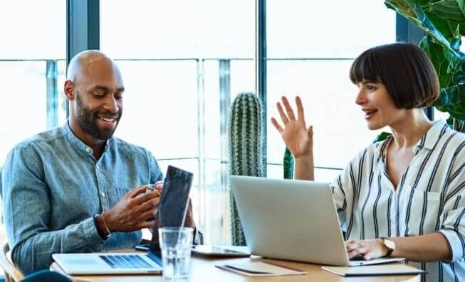 Man and woman in conference room having a meeting.