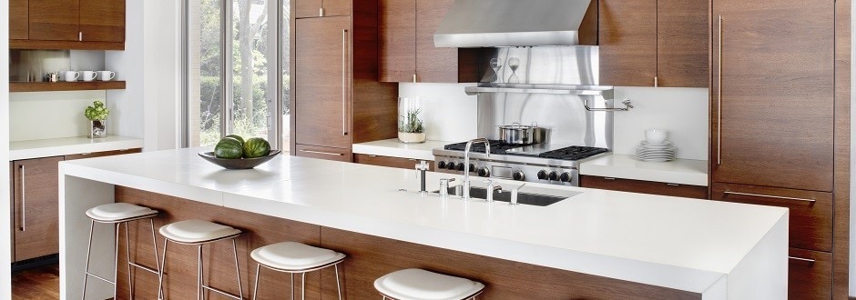 Kitchen interior with brown wood cabinets and island with stools